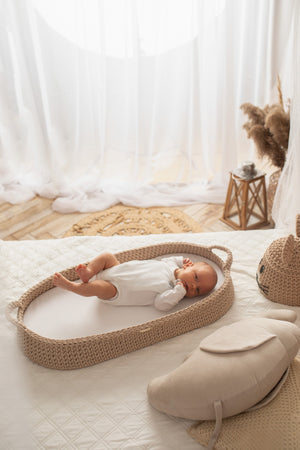 Baby in a Crochet changing basket