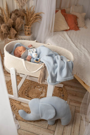 Cream handmade crochet moses basket in a white wooden stand