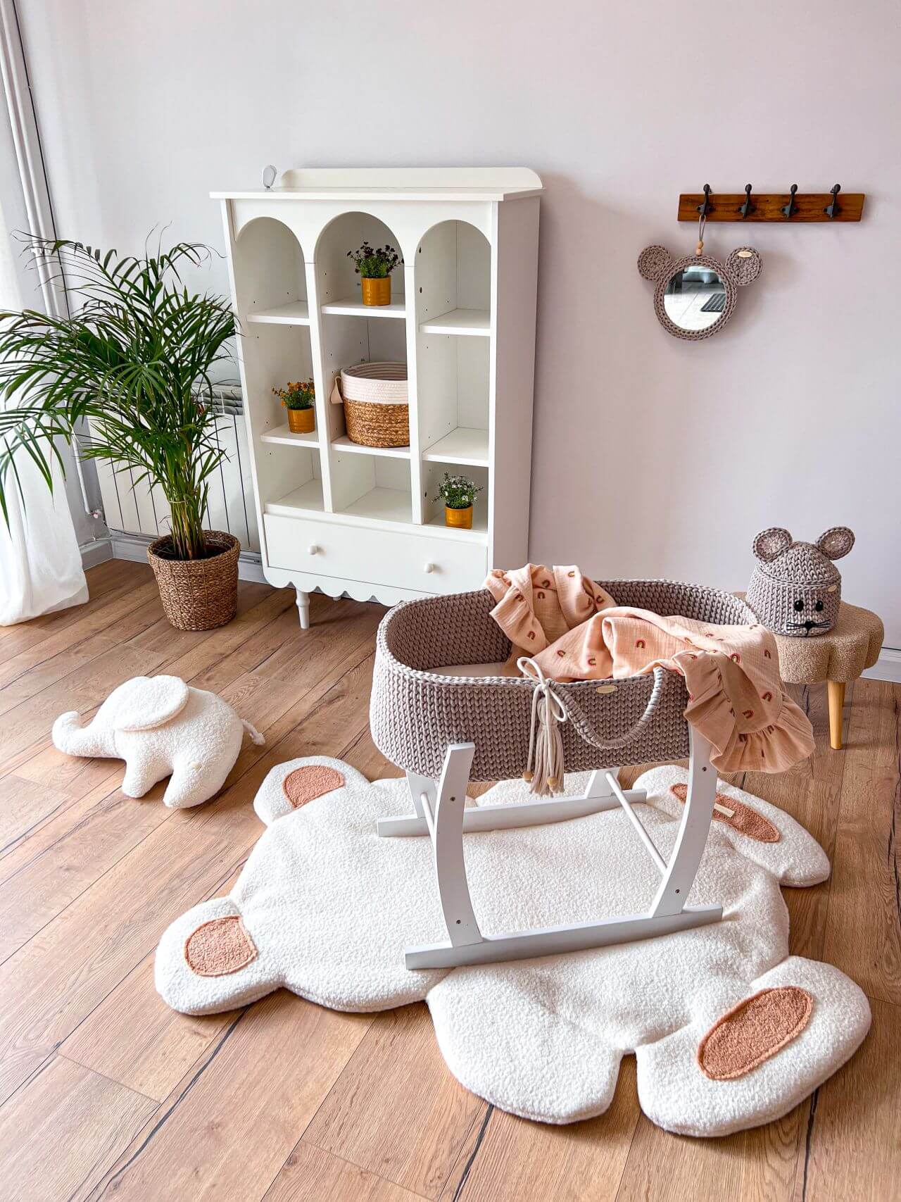 Grey-beige handmade crochet moses basket from The Baby Den in a white wooden stand